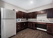 Thumbnail 20 of 40 - a kitchen with wooden cabinets and a stainless steel refrigerator