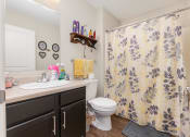 Thumbnail 19 of 36 - a bathroom with a sink toilet and shower