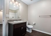 Thumbnail 23 of 40 - a bathroom with a sink toilet and a mirror
