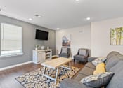 Thumbnail 4 of 12 - a living room with a couch and two chairs in front of a tv