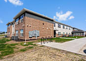 Thumbnail 1 of 38 - a brick building with a bike rack in front of it