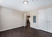 Thumbnail 22 of 40 - a renovated living room with white doors and wood flooring