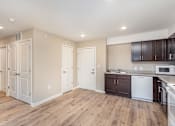 Thumbnail 23 of 42 - A kitchen with white appliances and wooden floors.
