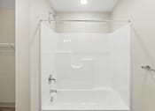 Thumbnail 31 of 31 - A white shower stall with a glass door and a white shower head.