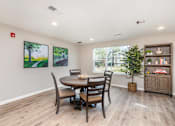 Thumbnail 25 of 42 - A dining room with a table and chairs.