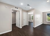 Thumbnail 21 of 40 - an empty room with white walls and wood floors