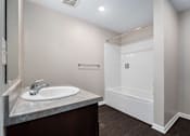 Thumbnail 17 of 40 - a bathroom with a sink and a shower and a mirror