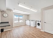 Thumbnail 23 of 30 - A laundry room with a washer and dryer in it.