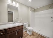 Thumbnail 25 of 43 - A bathroom with a white toilet and a white bathtub.