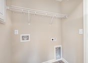 Thumbnail 34 of 42 - A white shelving unit is mounted on the wall above a white door.