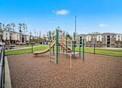 Thumbnail 30 of 43 - A playground with a slide and a green pole.
