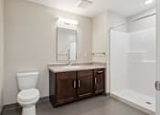 Thumbnail 26 of 38 - a bathroom with a toilet sink and shower and a mirror