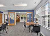 Thumbnail 8 of 49 - A room with a table and chairs in front of a window with blinds.