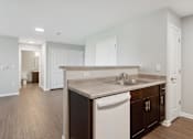 Thumbnail 33 of 38 - a white kitchen with a sink and a counter top
