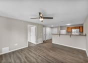 Thumbnail 12 of 51 - a living room and kitchen with a ceiling fan