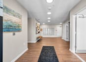 Thumbnail 34 of 38 - a long hallway with white walls and wood floors