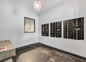 Thumbnail 13 of 51 - a room with mailboxes and a table