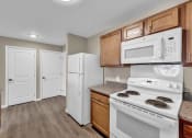 Thumbnail 10 of 51 - a kitchen with white appliances and wooden cabinets