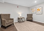Thumbnail 10 of 33 - a living room with two chairs and a table