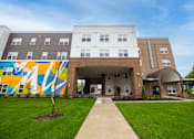 Thumbnail 6 of 58 - A building with a mural on the side of it.