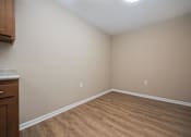 Thumbnail 9 of 58 - A room with wooden flooring and a white ceiling.