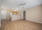 Thumbnail 23 of 58 - A room with a ceiling fan and wooden flooring.