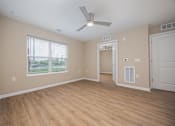 Thumbnail 20 of 58 - A room with a ceiling fan and wooden flooring.