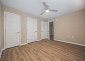 Thumbnail 19 of 58 - A room with a ceiling fan and wooden flooring.