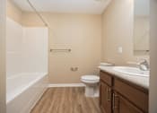 Thumbnail 30 of 58 - A bathroom with a toilet, sink, and bathtub.