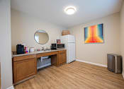 Thumbnail 45 of 58 - A kitchen with wooden cabinets and a fridge.