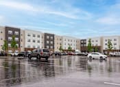Thumbnail 7 of 58 - A parking lot with cars and a building in the background.