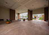 Thumbnail 55 of 58 - A large, empty room with a view of the outside through the windows.