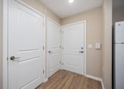 Thumbnail 12 of 58 - A white door is on the left and a white door with a handle is on the right.
