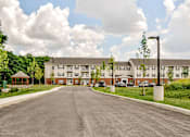 Thumbnail 53 of 56 - A large building with a parking lot in front of it.