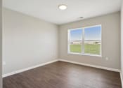Thumbnail 5 of 38 - an empty room with a window and wood floors