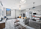 Thumbnail 16 of 51 - a living room with a gray couch and a coffee table