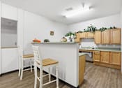 Thumbnail 14 of 66 - A kitchen with white cabinets and a white counter top.