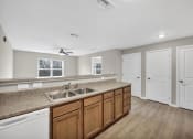 Thumbnail 3 of 51 - a kitchen with a sink and a counter top