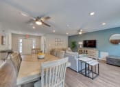 Thumbnail 19 of 50 - a living room and dining room with couches and a table
