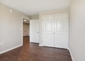 Thumbnail 32 of 38 - a room with white closets and a wood floor