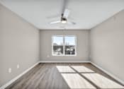 Thumbnail 3 of 18 - A room with a ceiling fan and a window with a view of a snowy landscape.