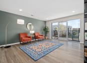 Thumbnail 5 of 35 - a living room with two orange chairs and a rug   and a sliding glass