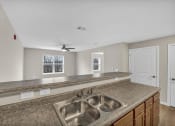 Thumbnail 4 of 51 - a kitchen with a sink and a counter top