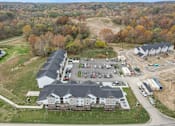 Thumbnail 4 of 84 - a view from above of a large building with a parking lot and other buildings