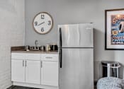 Thumbnail 14 of 51 - a kitchen with a sink refrigerator and a clock on the wall