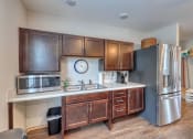 Thumbnail 23 of 50 - a kitchen with wooden cabinets and a clock on the wall