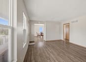 Thumbnail 19 of 43 - A room with wooden floors and white walls.