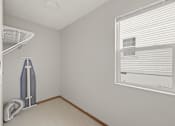 Thumbnail 13 of 43 - A room with a window and a wall-mounted fan.