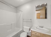 Thumbnail 30 of 43 - A white bathroom with a toilet, sink, and bathtub.