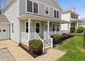 Thumbnail 40 of 43 - A house with a grey siding and white trim.